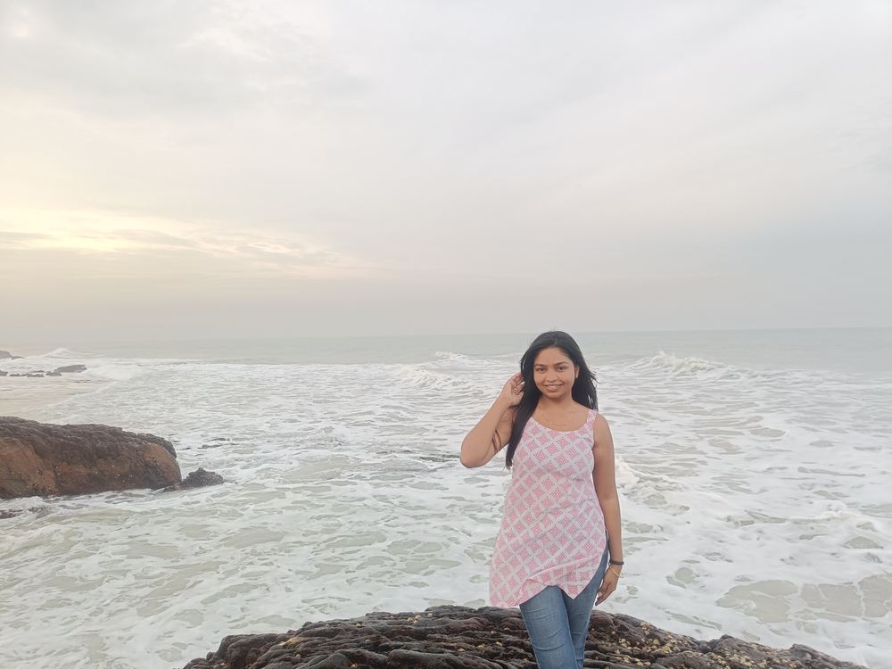 Shruti looking out at the ocean with a confident smile