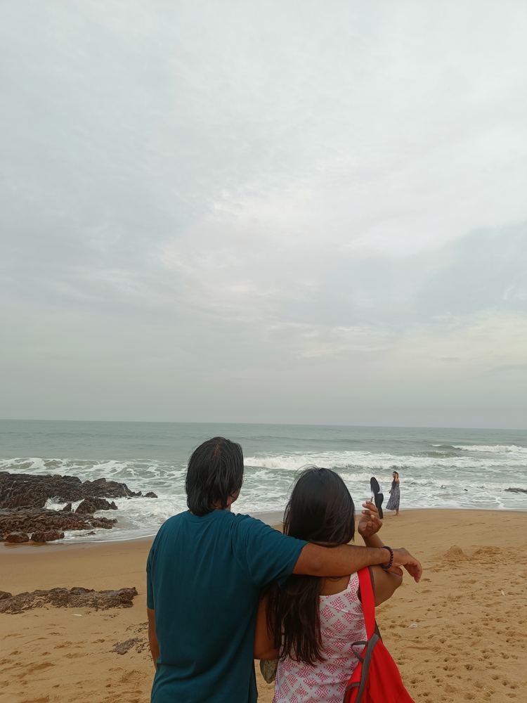 Shivam and Shruti from behind, looking out at the sea