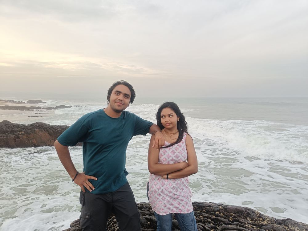 Shivam and Shruti posing on the rocks, one giving a side glance
