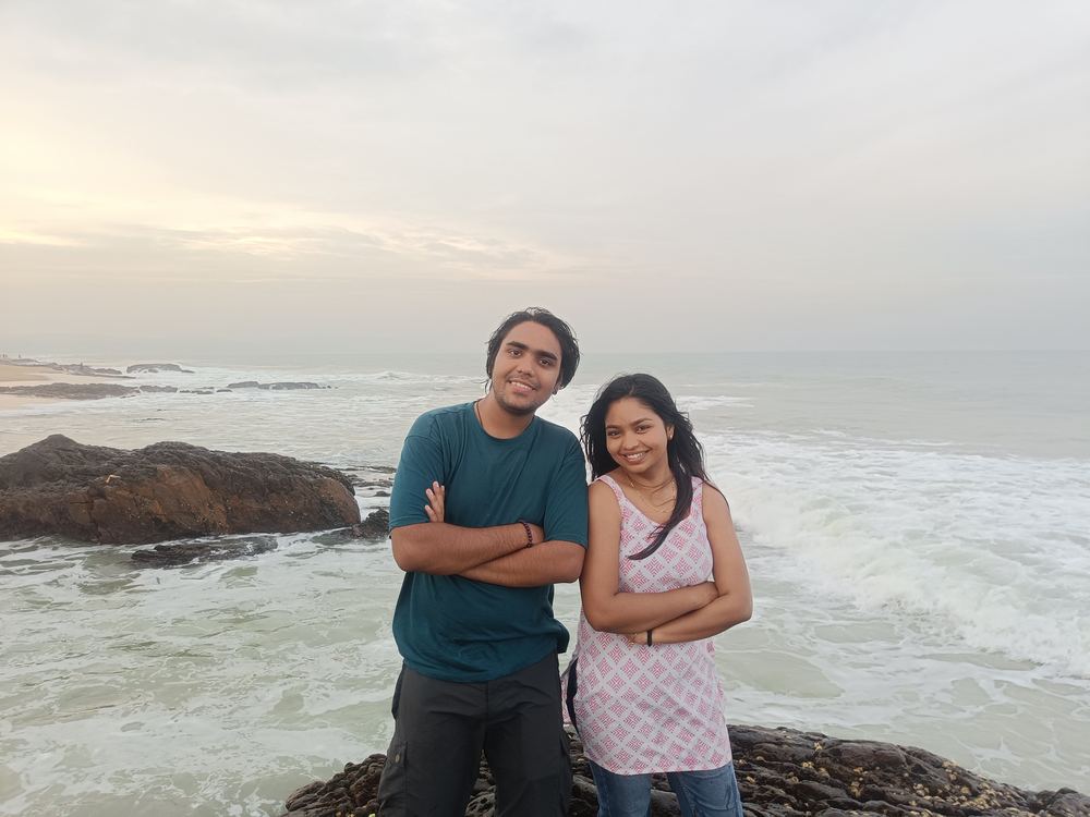 Shivam and Shruti standing arms crossed, matching smiles